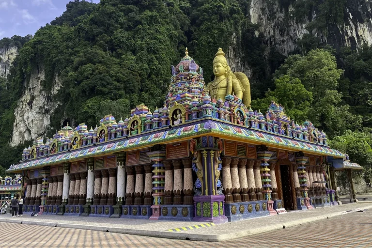 Vibrant Hindu temple and Lord Murugan statue at Batu Caves — a key landmark visitors will see when figuring out how to get to Batu Caves.