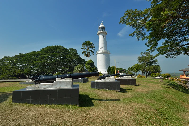 Historic cannons and Altingsburg Lighthouse at Bukit Malawati, one of the top heritage attractions in Kuala Selangor, Malaysia.
