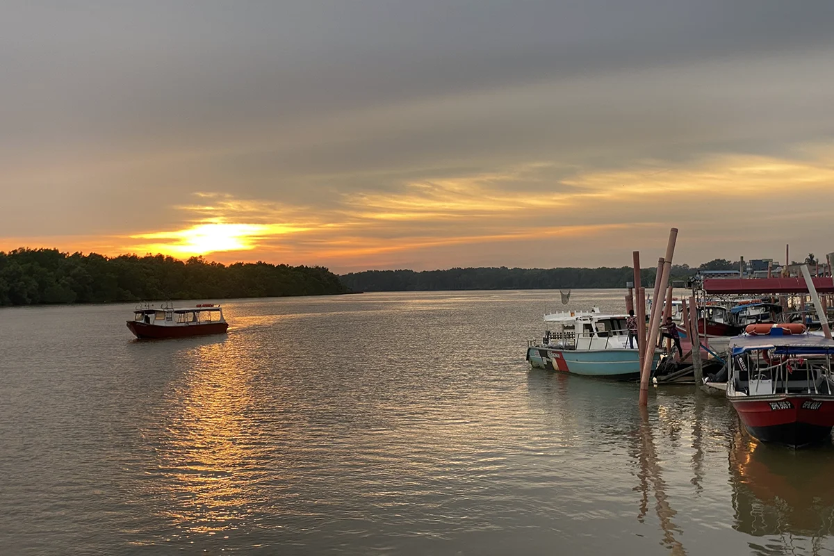 Sunset view at Selangor River jetty in Kuala Selangor, a highlight in the Kuala Selangor travel guide for evening firefly tours and riverside dining.