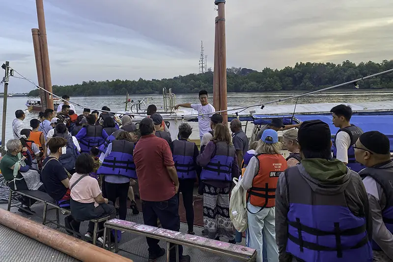 Tourists queue to board a fireflies tour boat at Pasir Penambang Jetty, Kuala Selangor