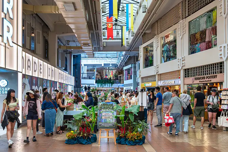 Tourists shopping for handicrafts and batik at Central Market — one of the best things to do in Kuala Lumpur for local shopping.