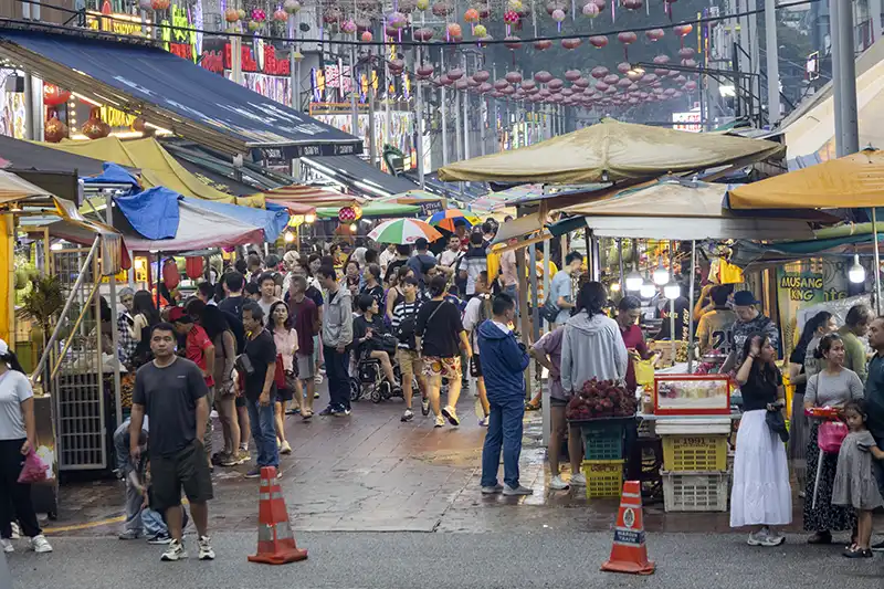 Crowds enjoying street food at Jalan Alor in Kuala Lumpur, one of the city’s most famous food streets.
