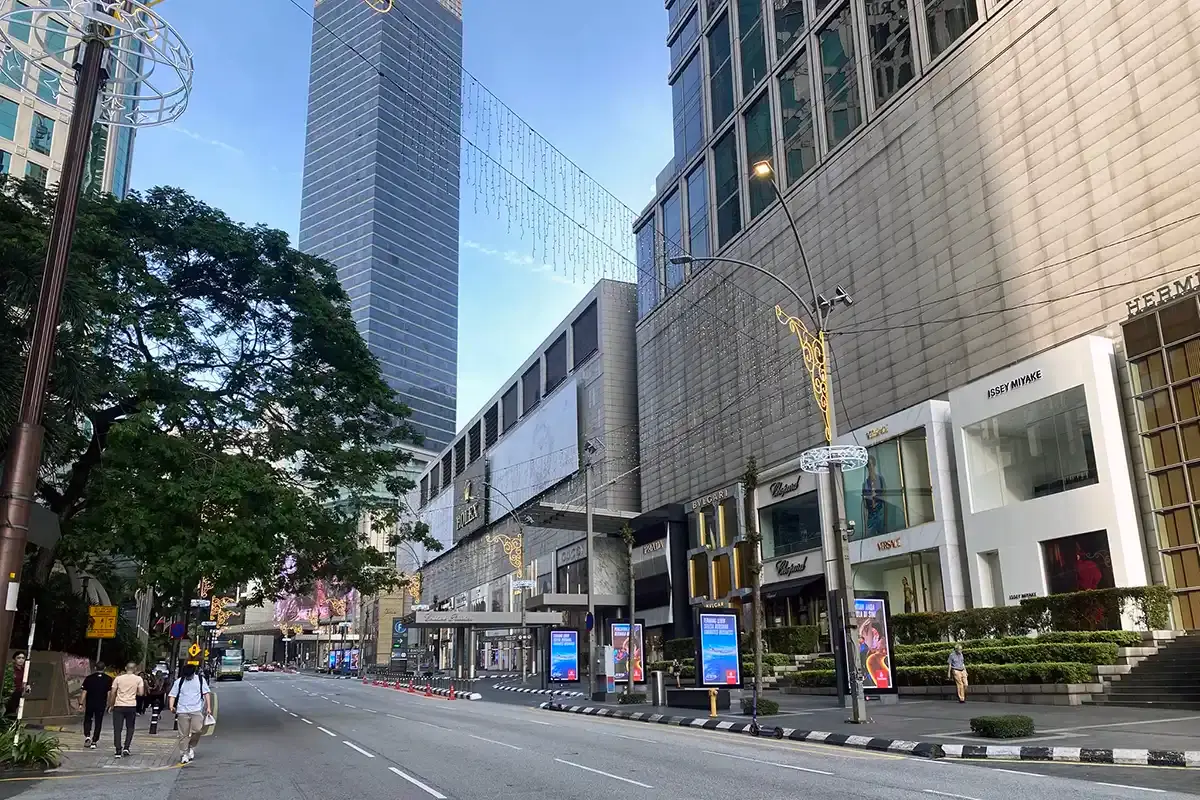 Morning view of Bukit Bintang in Kuala Lumpur, showing luxury boutiques, wide sidewalks and a lively shopping street that forms part of the city’s main lifestyle district.