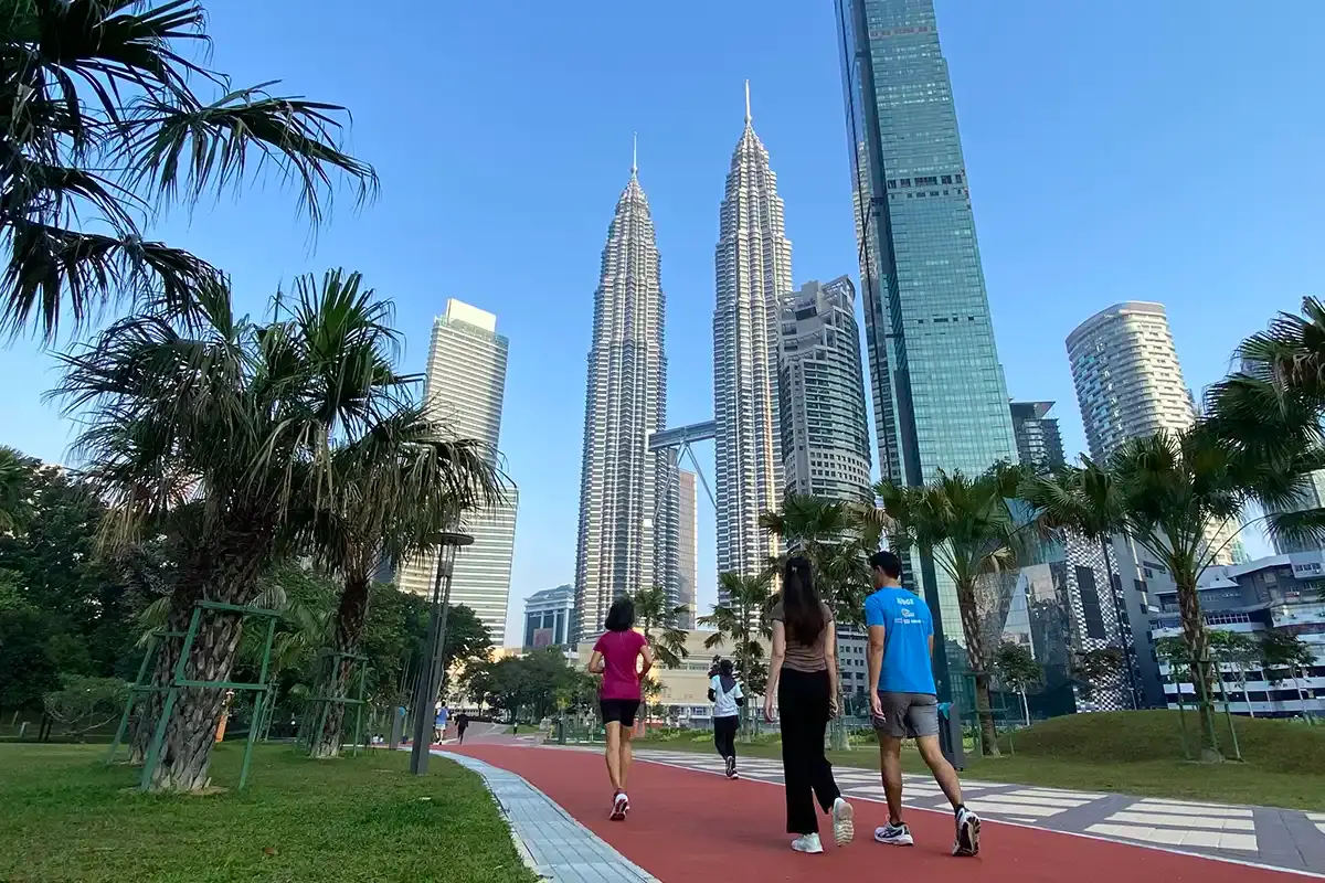 Joggers and walkers on the running track at KLCC Park in Kuala Lumpur, with the Petronas Twin Towers in the background. This central park is one of the city’s most popular free attractions.