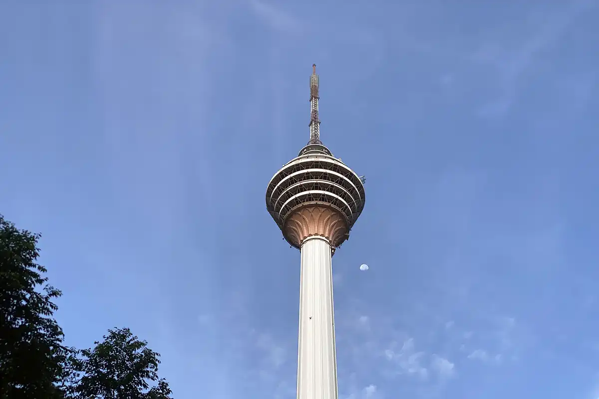 KL Tower standing against a clear blue sky, one of the best spots for panoramic city views in Kuala Lumpur.