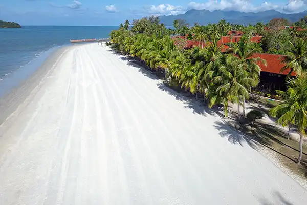Aerial view of the wide sandy shoreline at Cenang Beach in Langkawi