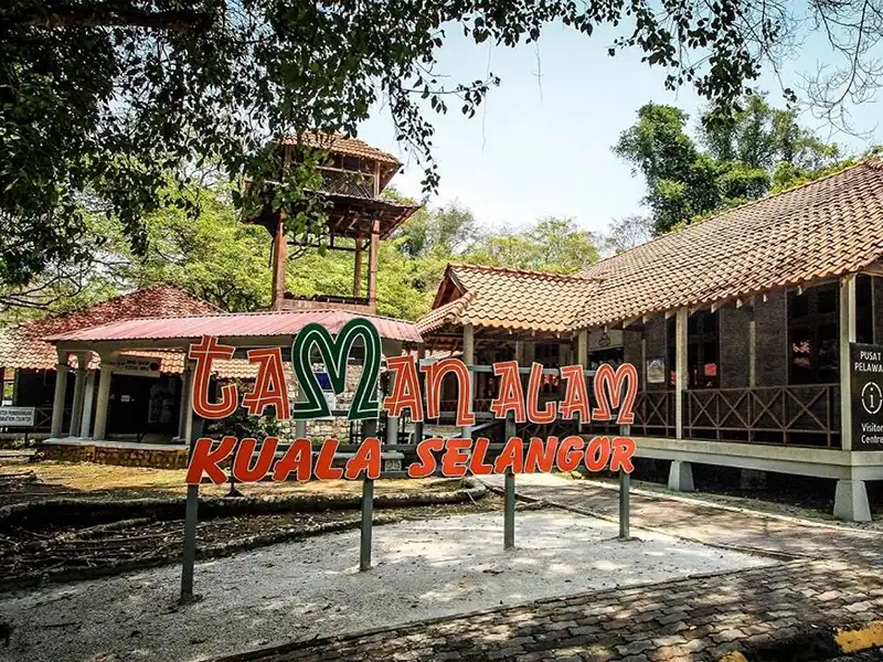 Entrance sign of Kuala Selangor Nature Park surrounded by mangrove forest
