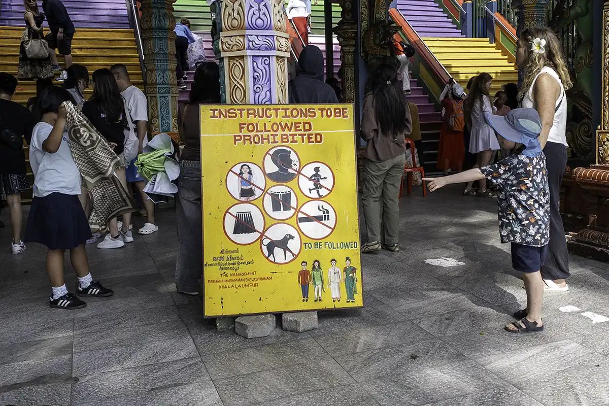 Dress code and behaviour guidelines displayed at the entrance of Batu Caves