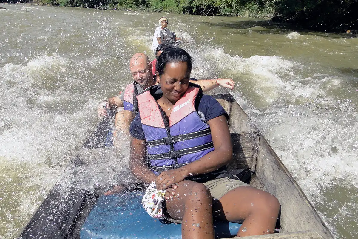 Visitors experiencing rapid shooting on a river in Taman Negara National Park, Pahang